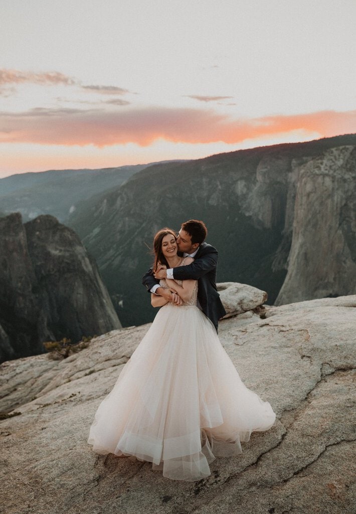 bride and groom embrace at sunset.