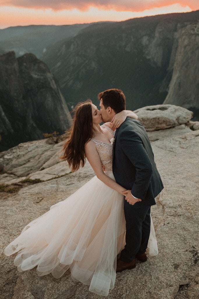 couple kiss to celebrate elopement at Yosemite national park.
