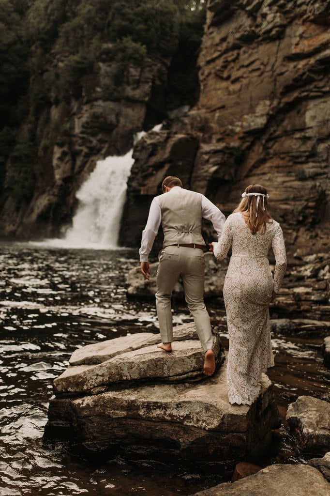 bride and groom hike in linville gorge wilderness.