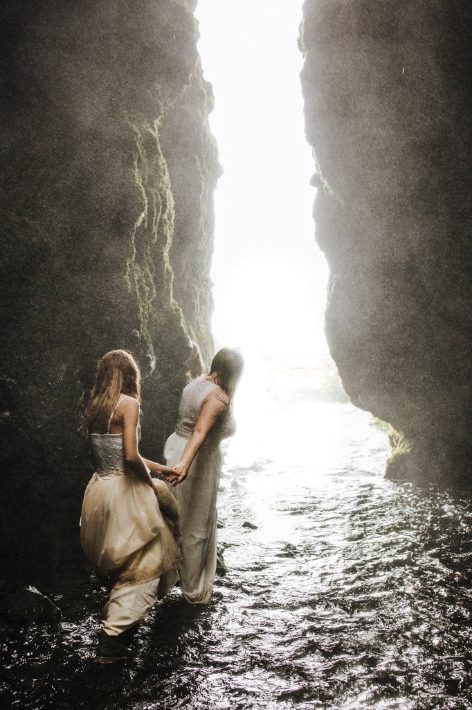 Brides hiking in Iceland cave.