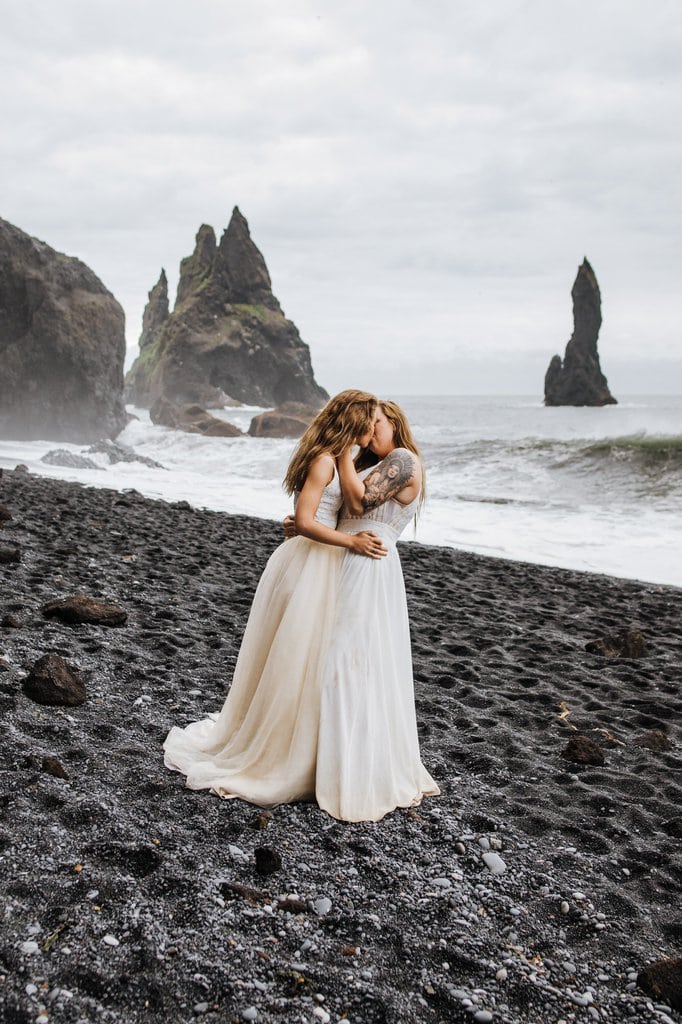 Brides kissing at the beach in Iceland.