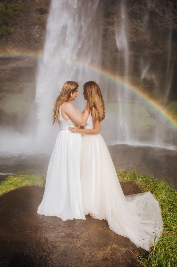 Brides looking at waterfall.