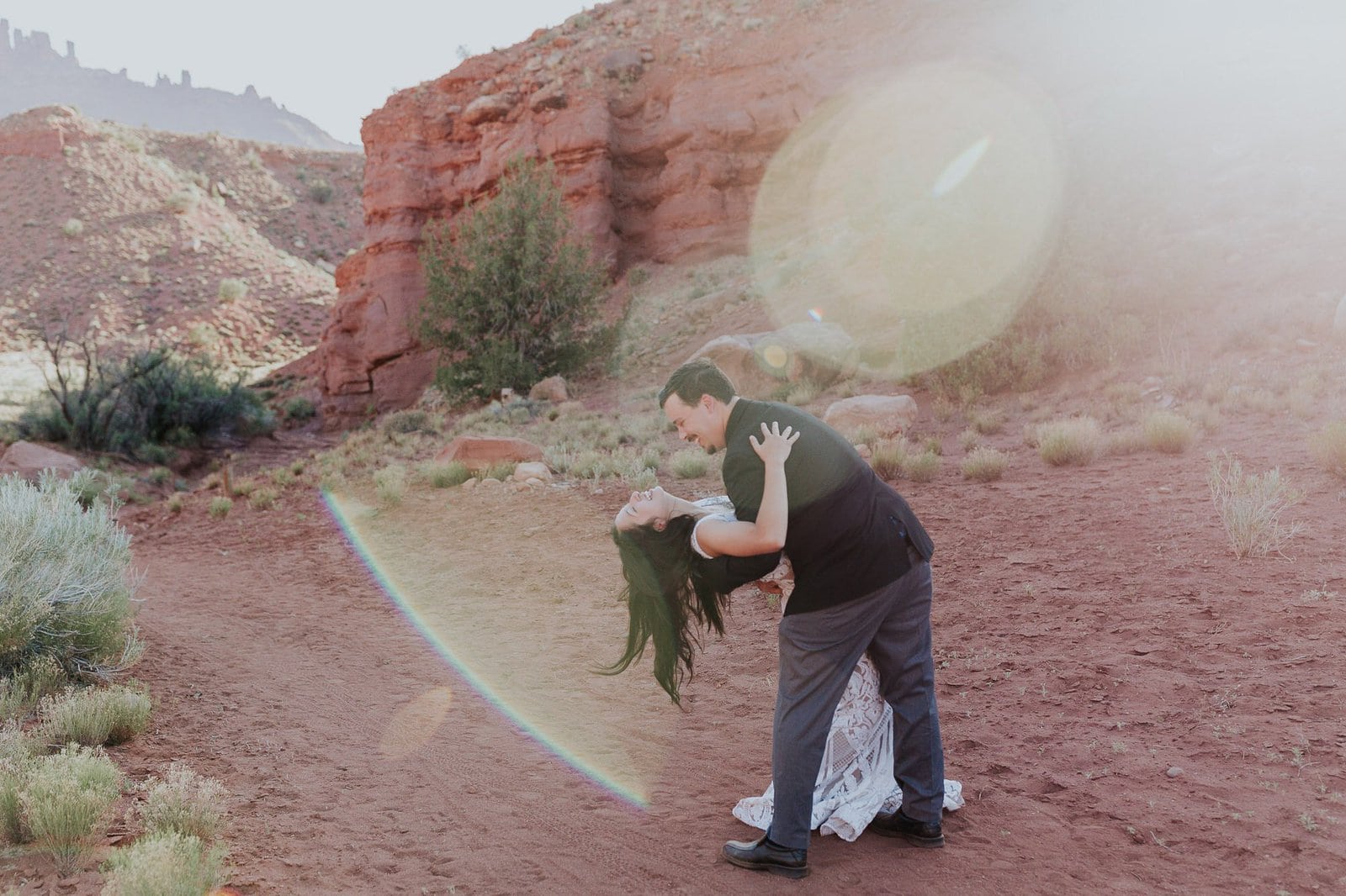 Groom dips his bride during elopement photo session.