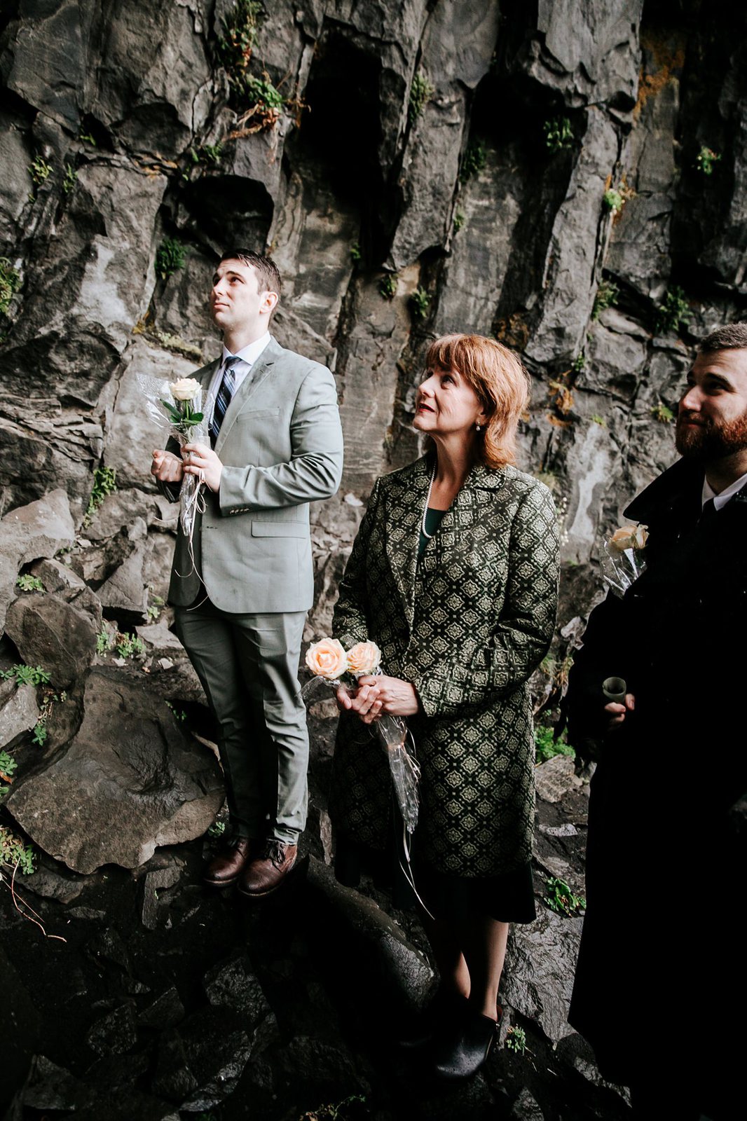 Intimate family at rainy Iceland ceremony.