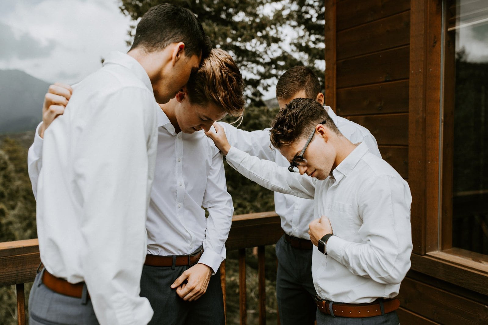 groomsmen say pray with groom.