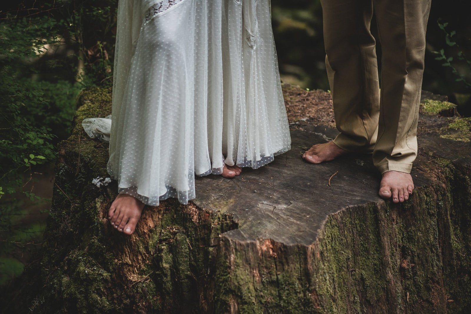 Detail shot of bride and groom bare feet.