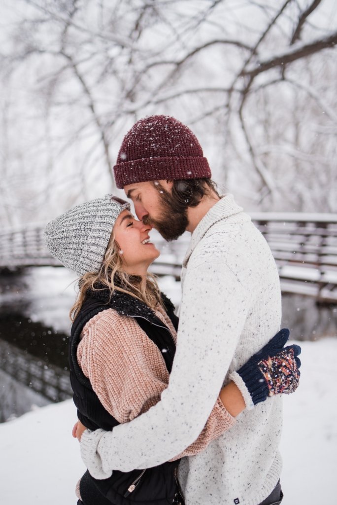 couple kissing during winter session.