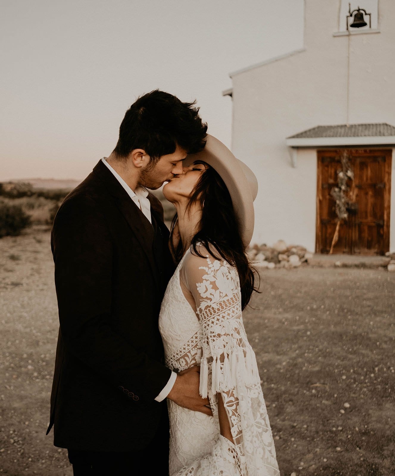 bride and groom kiss.